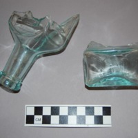 Neck and base of the bottle. Seams from a mold are visible on the neck, and a pontil mark can be seen on the base, which is flat with no noticeable kick-up.