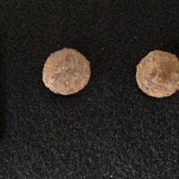 A composite image of the front and back of the copper alloy shank button, with scale.