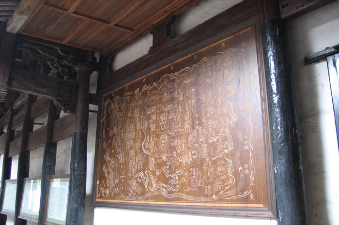 Carved wooden map on left wall Carved wooden map on left wall