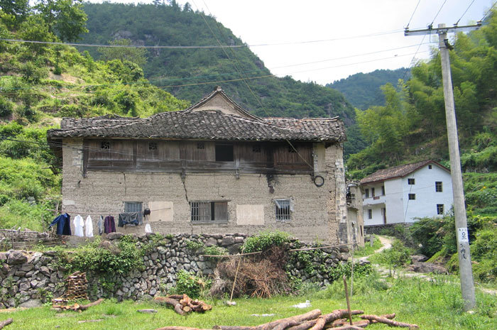 house with mountain and road