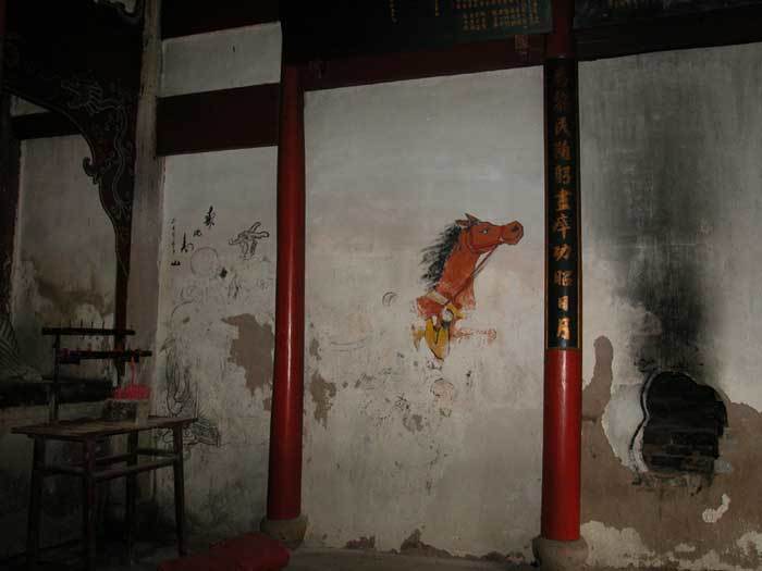 A horse painting on the left-hand side wall in the hall