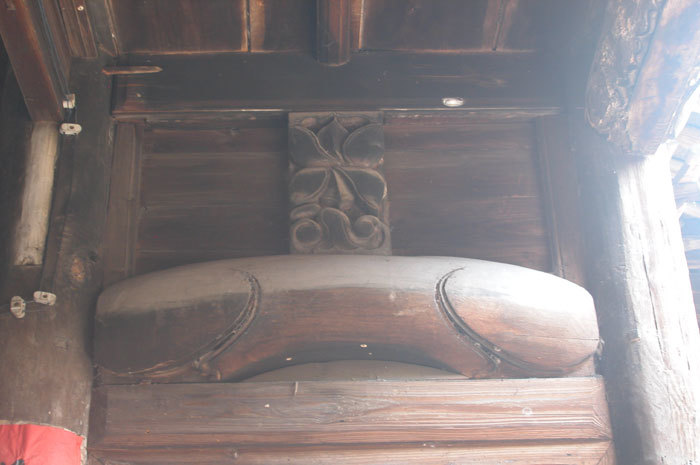 wood carving opposite small beam below second storey with lotus