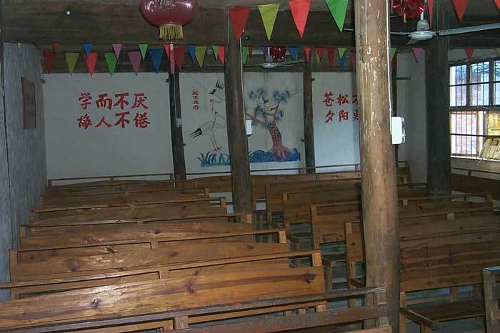 Back wall of the school. On the wall is a portrait of a pine tree and cranes, symbolizing longevity