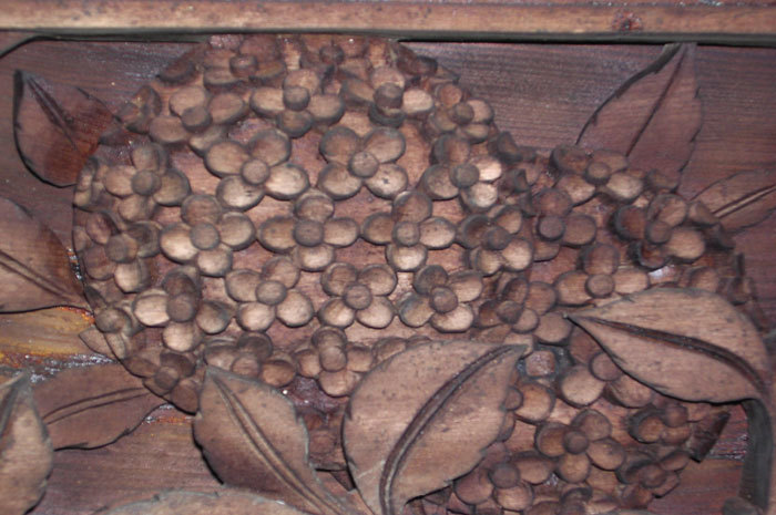 close-up of flower carving on ceiling cross beam.jpg