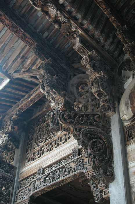 Carved wooden bracket above square left front pillar in left wall