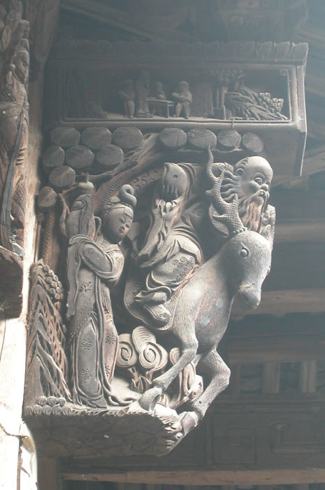 bracket of man on deer with peach and attendant maiden