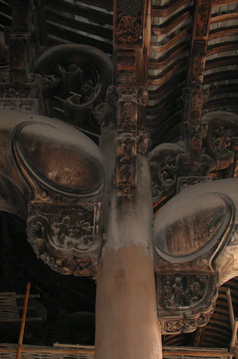 Brackets on both sides of large left center pillar.