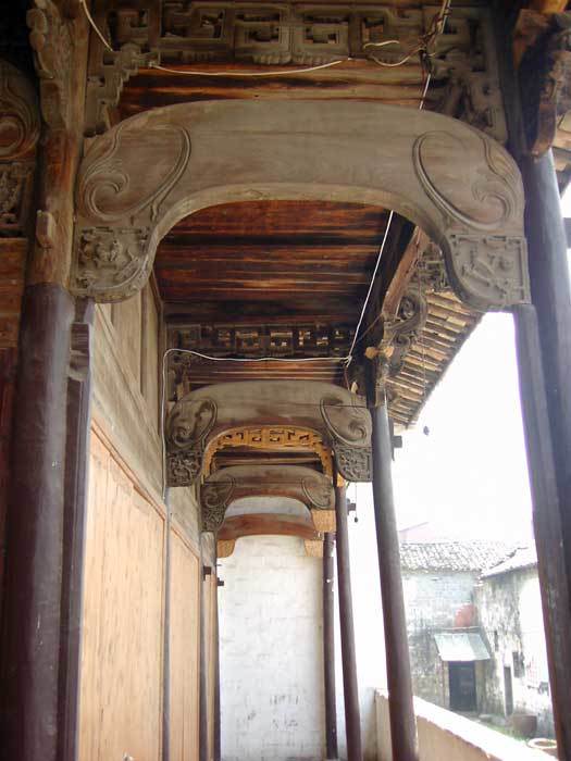 Long view of upper wooden brackets with both old and new elements , right side of beam structure