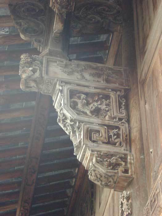 Carved brackets with rural themes on the left-hand side (on the top of the 3rd pillar)