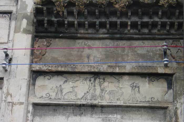 Looking through the front gate from the hall-wall paintings on the right-hand side of the front wall