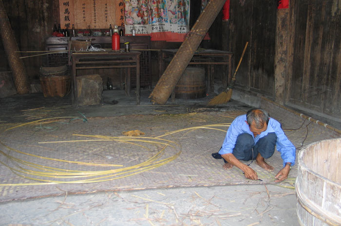 man weaving mat