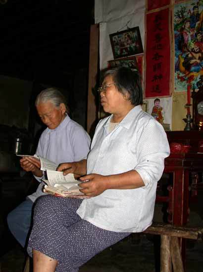 Old ladies Li Xianyuan and Deng Zaoxiang talking about Li`s dream of Lord Yang starting their project of restoring the temple Old ladies Li Xianyuan and Deng Zaoxiang talking about Li`s dream of Lord Yang starting their project of restoring the temple