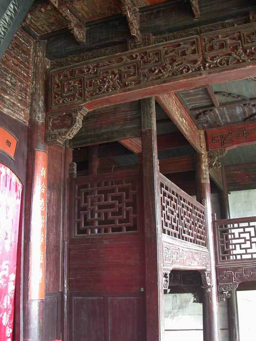 Carved, painted beams and balcony around the stage