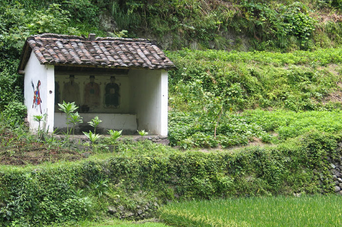 small temple with four painted figures