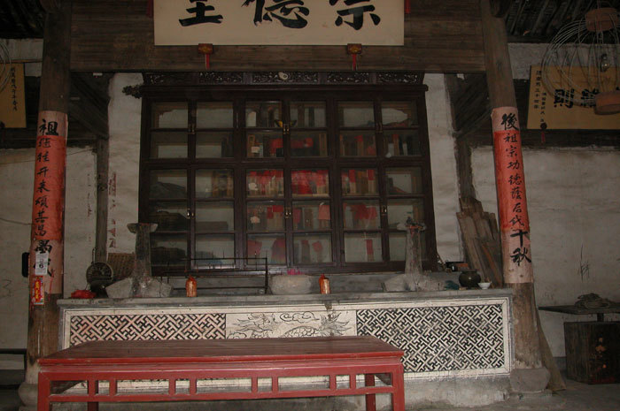cabinet with spirit tablets, altar, and mural of dragon