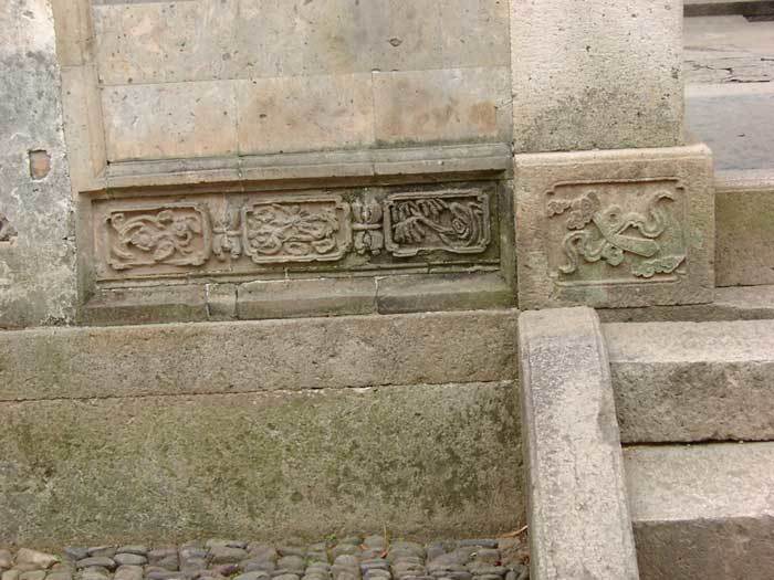 Relief carvings on portal base with natural themes