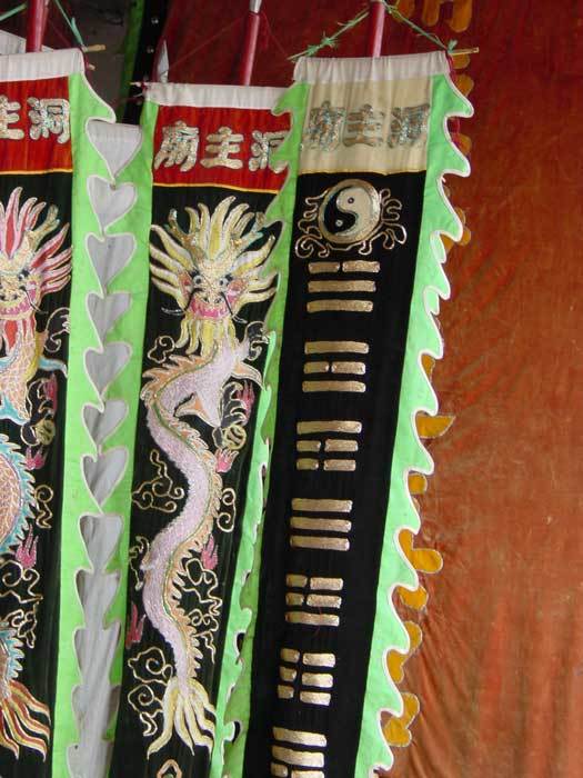 Close-up of the flags. The symbols on the right-hand side flag are the eight diagrams from the Book of Change