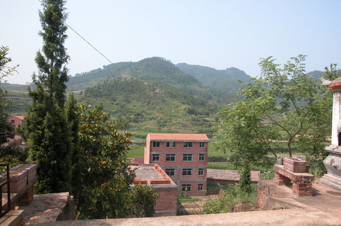 Southern view from temple entrance with building under construction.