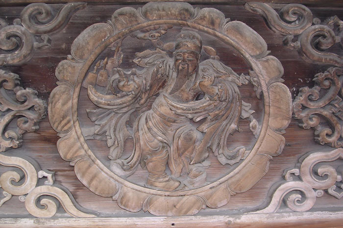 close up of center carving on side-wall just below eaves
