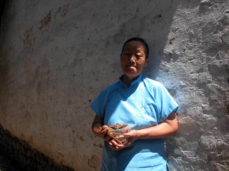 An old women holding her lunch at 10.35 am An old women holding her lunch at 10.35 am