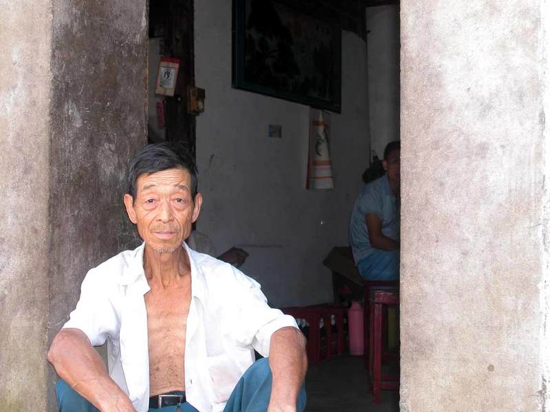 An old man sitting on his door An old man sitting on his door