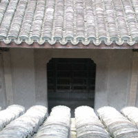 Hall entrance door viewed from central upper window showing tiles and pillar carving