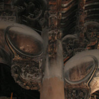 Brackets on both sides of large left center pillar.