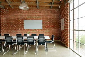 meeting room made of red bricks with a large window
