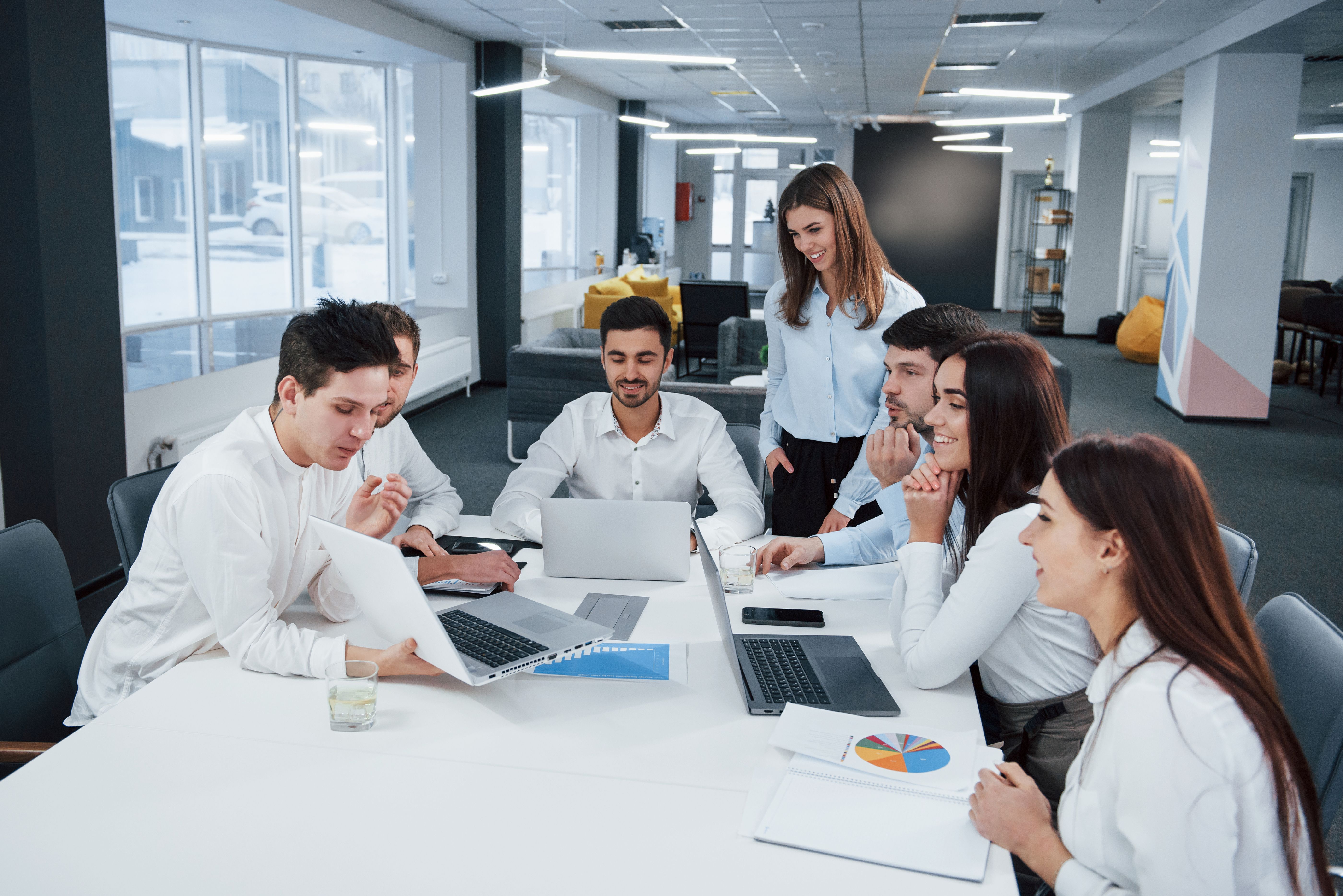 showing-good-results-group-young-freelancers-office-have-conversation-smiling