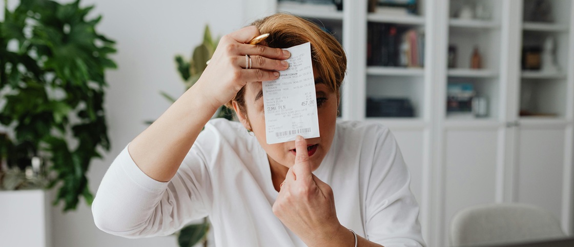 Woman checking receipts that require invoice automation for faster expense management.