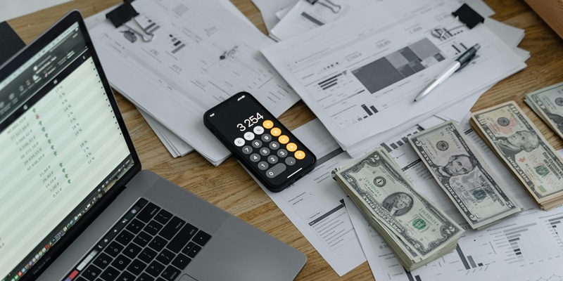 Laptop and calculator on financial documents