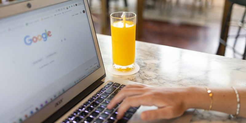 Remote worker searches Google for SEO tips while enjoying fresh juice
