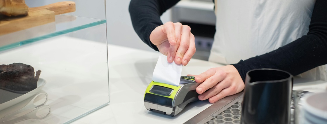 Retail terminal printing a receipt ready for digital processing via invoice automation.