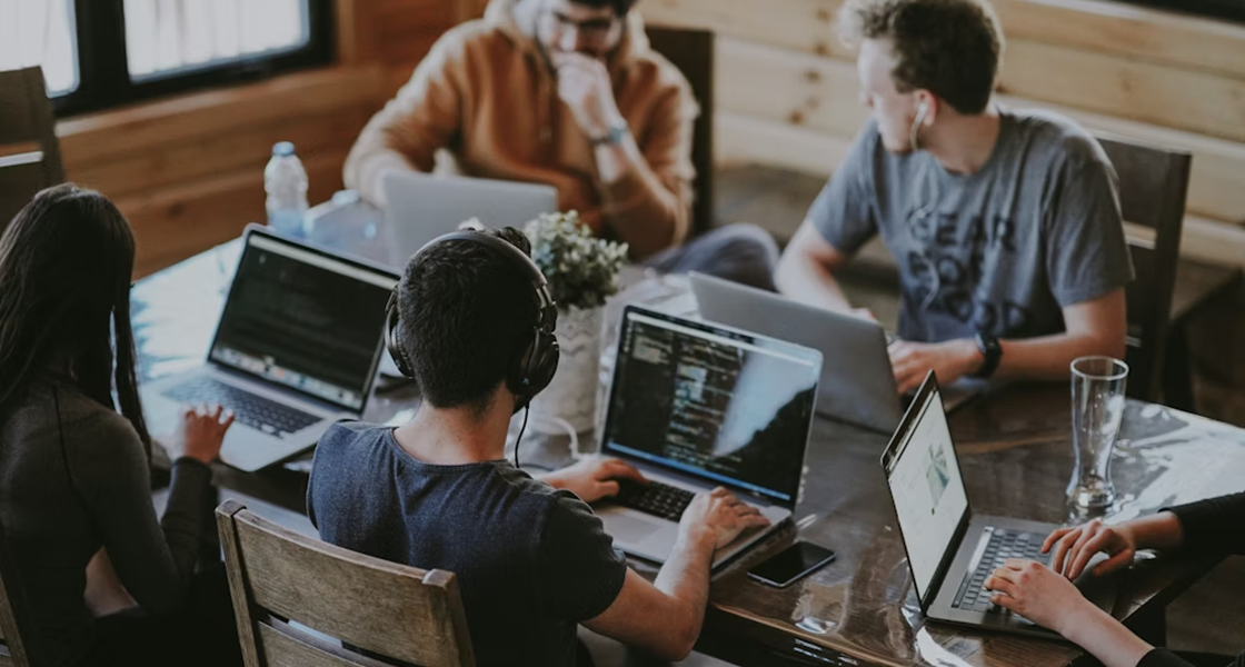 A team of professionals collaborating on high-value strategy tasks in a modern office.