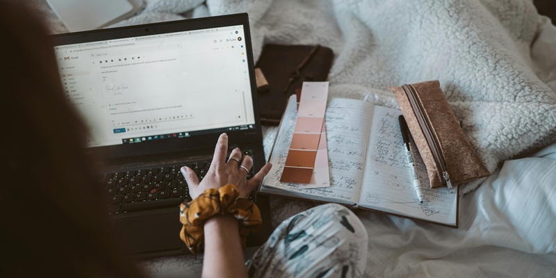 Hand composing a Gmail email showing time saving from email automation