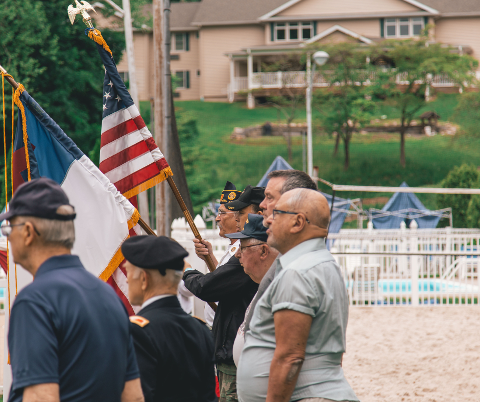 Veterans carrying American flags during a ceremony