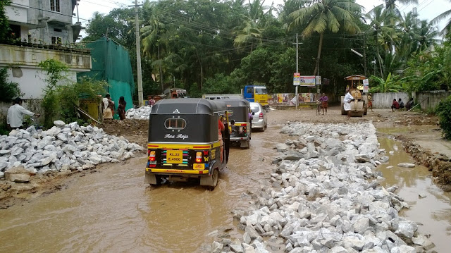 Auto-rikshaws can travel over land and water alike. A scene from Kazhakkuttam-Menamkulam road