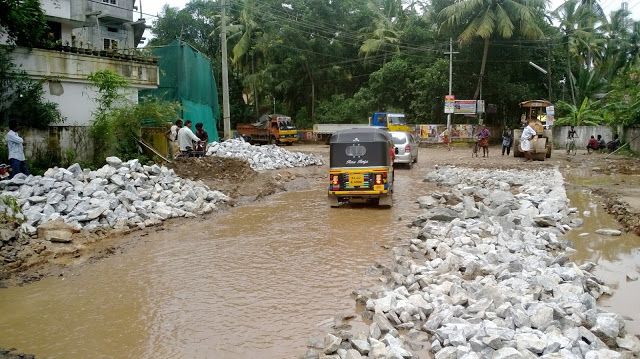 Wonder how the rains could dig trenches that take truckloads of rocks to fill. Was the Kazhakkuttom-Menamkulam road hollow to start with?