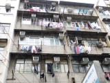 Grauwe flats, de was hangt boven al het verkeer, in de smog, te drogen