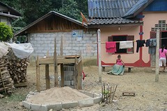 Little local is doing the laundry outside
