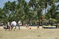 Denise is playing soccer with the locals