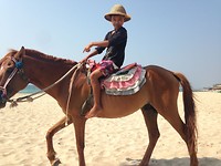 Local kid is asking us if we want to ride the horse.
