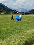 Met veel wind is het tobben om de parachutestof in de zak te krijgen.
