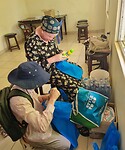 Filling the bags for the cliënts.  Sunscreen,  lipbalms water, Mahambri and ugali.