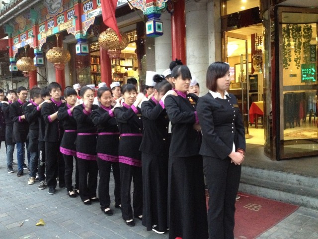 Personeel voor een restaurant in Beijing krijgt instructie en doen hun dagelijkse massage