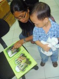 Minette (social worker) shows the welcome album to Ken