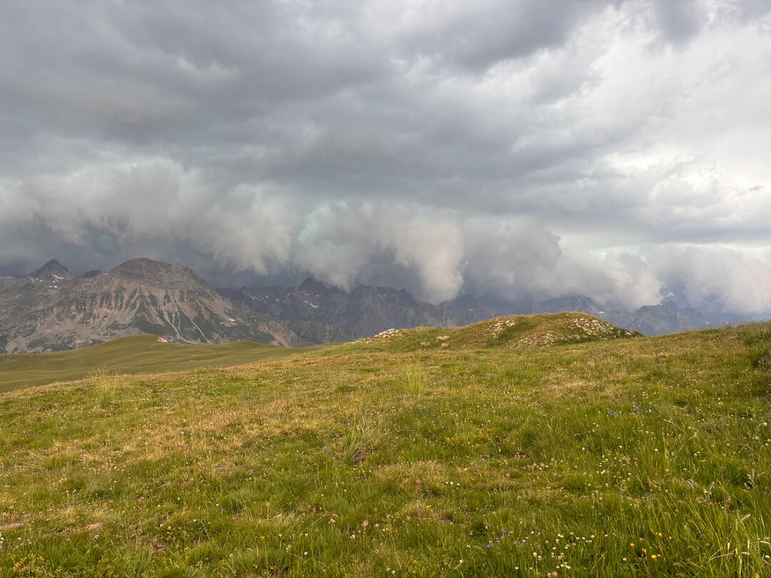 opeens komen er wolken over de bergkam in de verte
