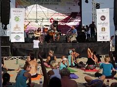 Daphne Tse sings during beach yoga session