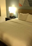 bed with sheets and blankets