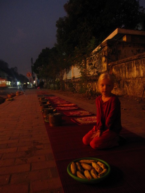 Fien zit om kwart voor zes klaar voor de monnikenprocessie in Luang Prabang